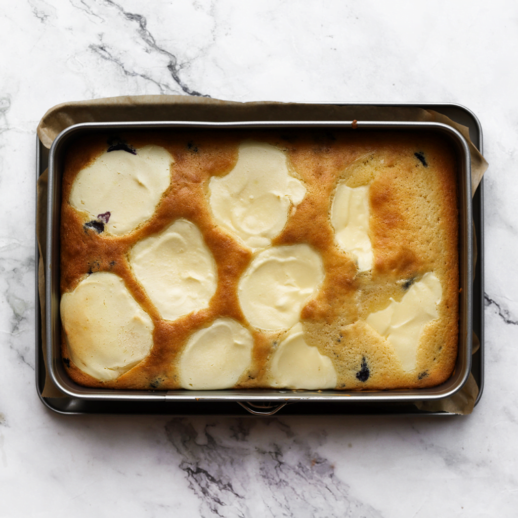 Zet de bosbessencheesecake in een voorverwarmde oven op 160 ℃. Bak 30-35 minuten, of totdat de randen diep goudbruin zijn gekleurd. Houd de baktijd zelf in de gaten, want elke oven werkt anders. Laat afkoelen.