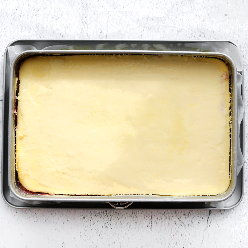 Zet de speculooscheesecake met aardbeienvulling in een voorverwarmde oven op 125 ℃. Bak 60 minuten of tot de zijkanten stevig zijn en het midden nog een beetje wiebelt. Schakel de oven uit en laat de speculooscheesecake 1 uur in de oven liggen. Dit voorkomt dat de cheesecake inzakt/scheurt.
