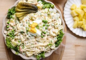 Zelfgemaakte huzarensalade met aardappel, ei, augurk en kipgrillworst