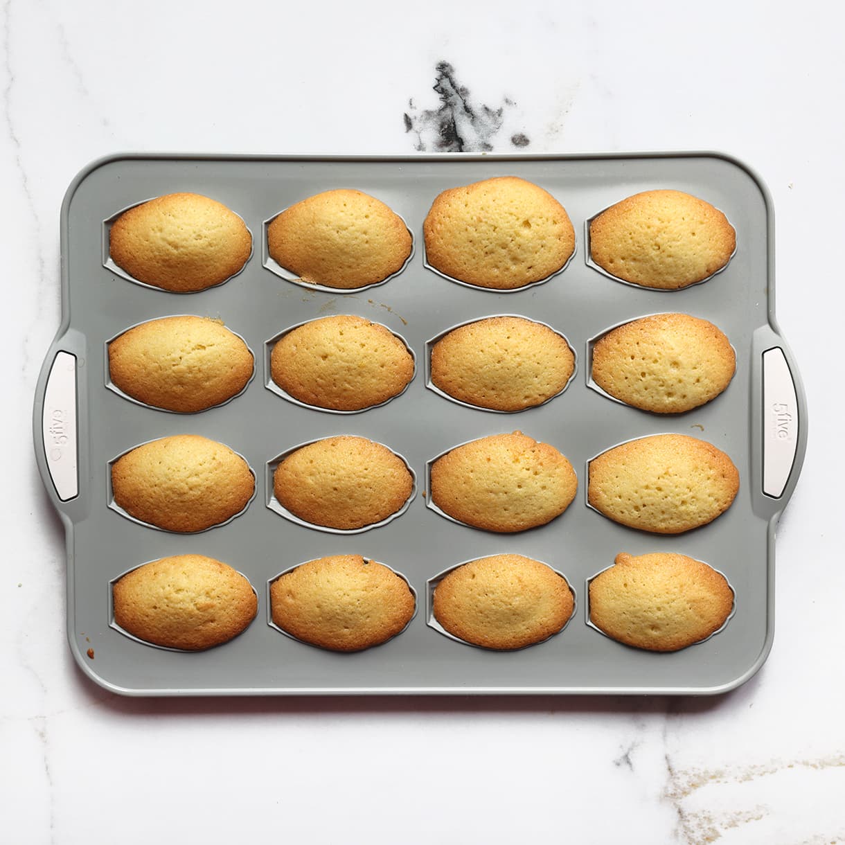 Madeleines bakken in de oven tot ze goudbruin zijn