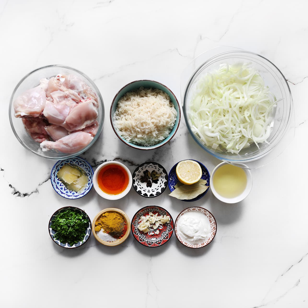 Saffraandraadjes in gekookt water voor het maken van kip biryani en alle ingredienten klaar leggen