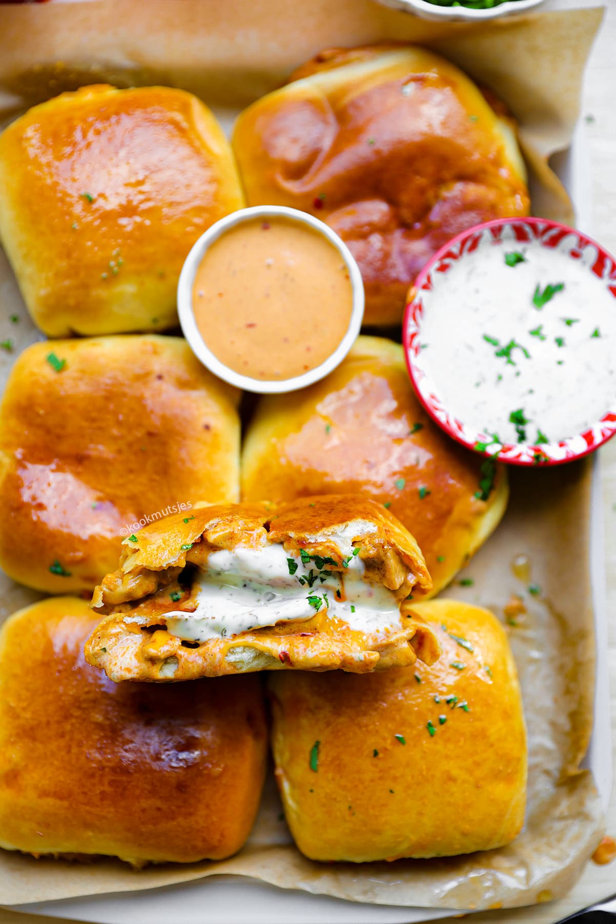 Close-up van goudbruine buffalo chicken broodjes met een pittige kip-kaasvulling